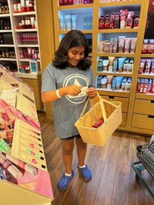 Hailey picks out lotions and sprays at Bath & Body Works during her Toby’s Dream Foundation shopping spree.