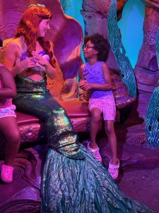 Girl talking with Ariel from The Little Mermaid during Disney World Dream trip.